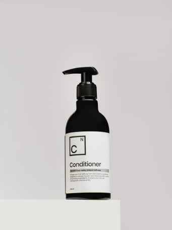 Front view of Dr. Elements Hair Conditioner bottle designed for damage repair, frizz control, and shine restoration.