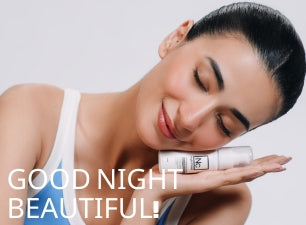 Model resting her head on her hand while holding Dr. Elements night repair product
